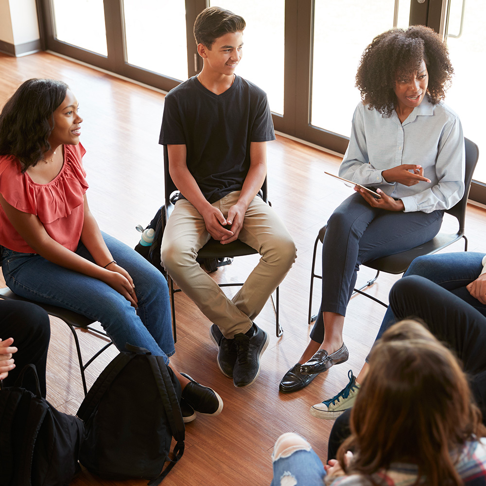 female tutor leading discussion group
